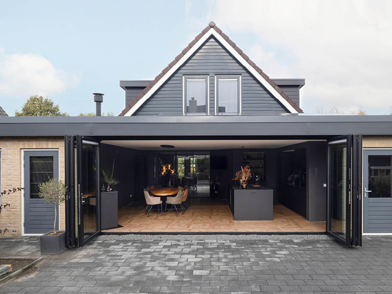Geopende serreaanbouw met moderne keuken